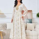 white dress embroidered with gold, a luxury that speaks of femininity