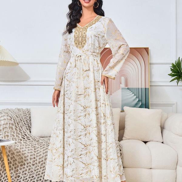 white dress embroidered with gold, a luxury that speaks of femininity