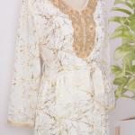 white dress embroidered with gold, a luxury that speaks of femininity