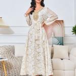 white dress embroidered with gold, a luxury that speaks of femininity